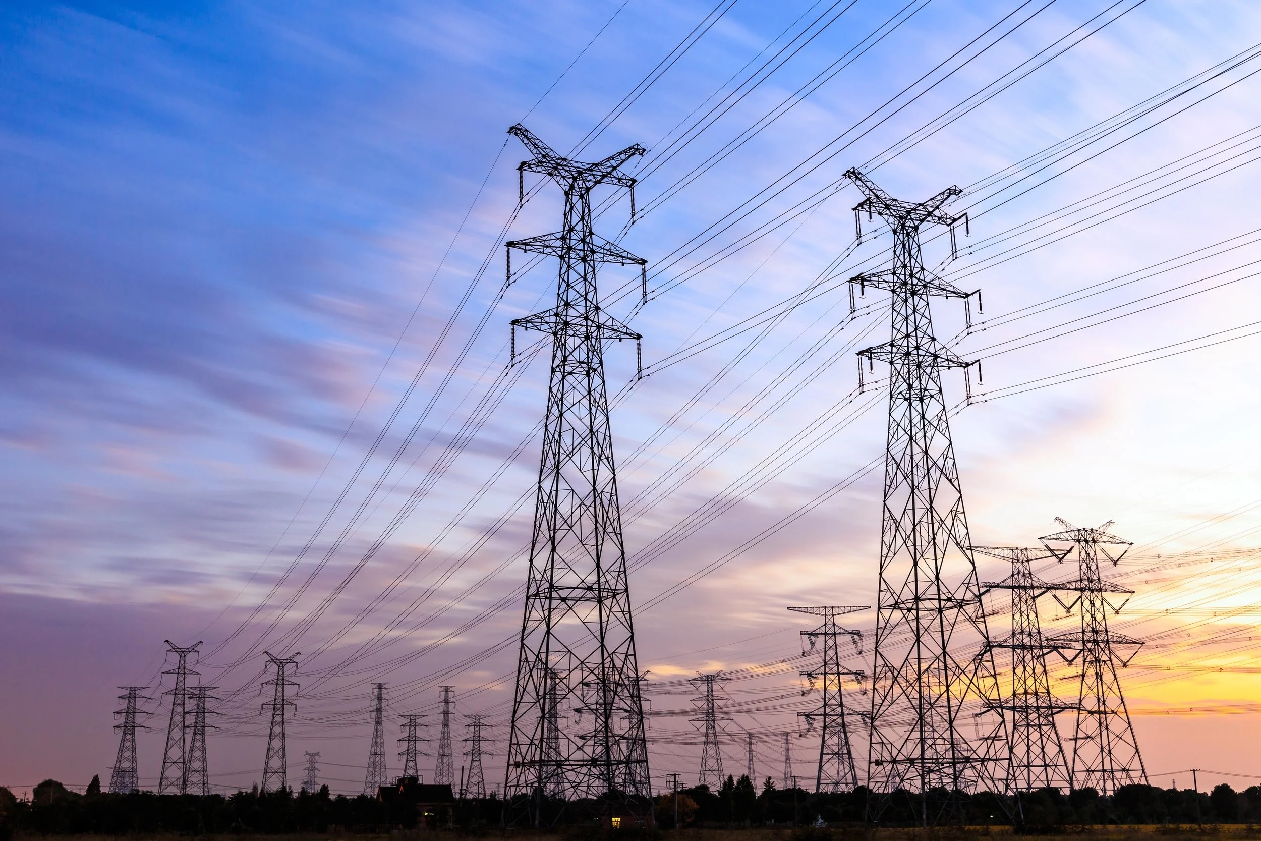 High voltage power tower landscape at sunset