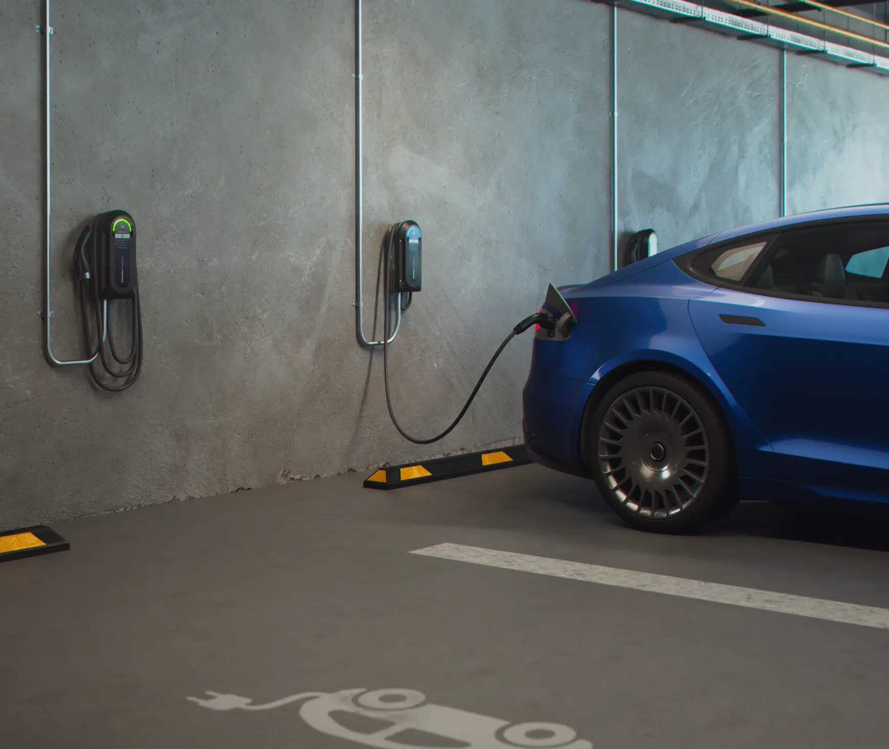 Wall-mounted Level 2 chargers beside a blue electric vehicle in a parking garage.